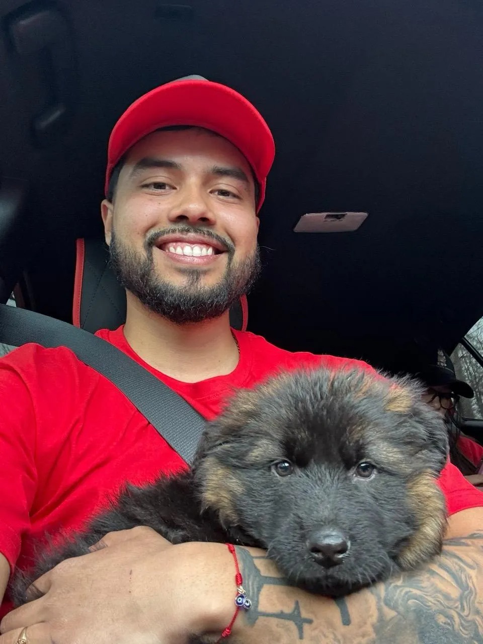 Luis, owner of LBP Dog Waste Services, holding a German Shepherd puppy
